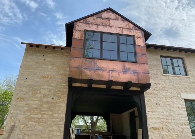 Copper metal panel facade on a stone building for Skylight Installation in Carmichael